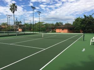 a tennis court with two tennis courts at Juquehy - Condomínio de Frente para o Mar - Piscina Aquecida - Quadra de Tenis in Juquei