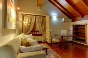 a living room with a couch and a table at Hotel Pousada Florença in Gramado