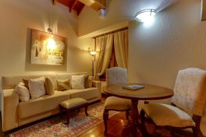 a living room with a couch and a table at Hotel Pousada Florença in Gramado