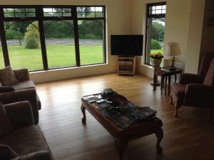 a living room with a couch and a coffee table at Auntie B's in Ardara