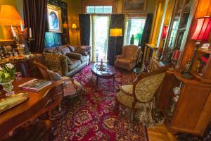 a living room with a couch and a table at Russell Manor Bed & Breakfast in Morrisburg