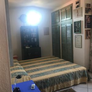 a bedroom with a bed and a blue table at La Chiave di Violino in Olbia