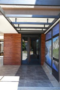 an entrance to a building with glass doors at Atrijum Apartments and Rooms - Đerdap Boat Tours in Kladovo +31 photos