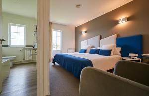 Un pat sau paturi într-o cameră la Hotel Gastronómico Boa Vista