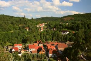 a town in the middle of a hill with trees at Café und Pension Theodor Fontane in Altenbrak