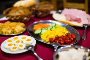 a table with a plate of food with eggs and vegetables at Penzion U Barana in Trojanovice