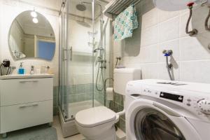 a bathroom with a washing machine and a shower at Apartment Luna in Malinska +47 photos