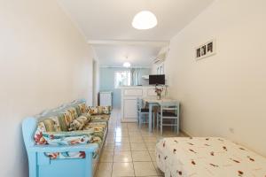 a living room with a couch and a table at Panorama Apartments updated with infinity pool in Agios Nikolaos
