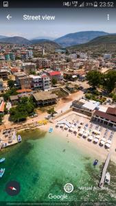an aerial view of a beach with umbrellas at Seafront apartment in Ksamil
