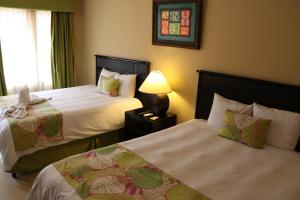 سرير أو أسرّة في غرفة في Coco Beach Hotel