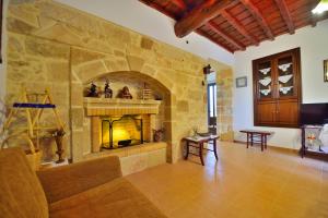 a large living room with a stone fireplace at Archontiko Ilias in Kavoúsion