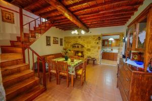 a kitchen and dining room with a table and chairs at Archontiko Ilias in Kavoúsion