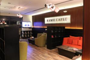 a waiting room with a couch and a television at شقق درر رامه للشقق المخدومة 3 in Riyadh