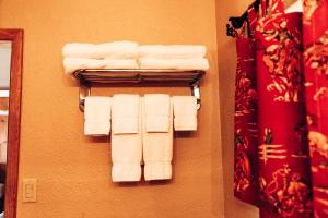 a group of white towels hanging on a wall at The Longhorn Ranch Resort Lodge & RV Park in Dubois