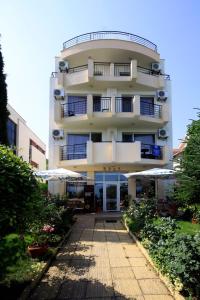 a tall building with a walkway in front of it at Hotel Briz in Burgas