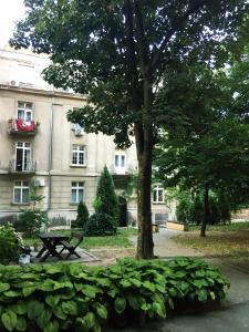 a park with a picnic table in front of a building at Apartment Auer_Belgrade in Belgrade