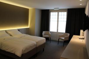 En eller flere senge i et værelse på Hotel Astel
