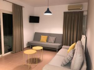 a living room with a couch and two tables at Kleanthi Studios in Chania Town