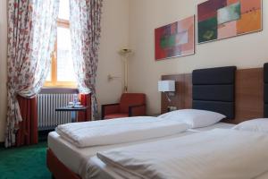 Postel nebo postele na pokoji v ubytování Hotel Grünwald