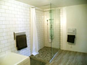 a bathroom with a shower with a glass door at La Gauviniere in Liez