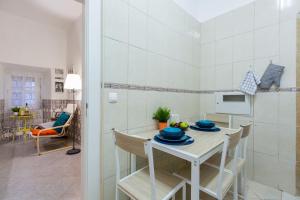 a kitchen and dining room with a table and chairs at Santos Neighborhood Apartment in Lisbon +37 photos