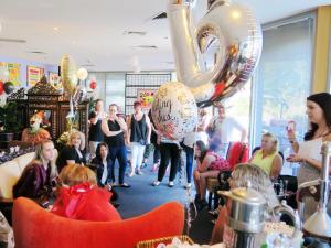 a group of people standing in a room with balloons at New Norfolk Junction Motel in New Norfolk