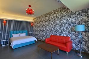 a bedroom with a bed and a red chair at Whitecaps B&B in Yanliau