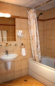 a bathroom with a sink and a toilet and a shower at Hotel Izvora - Garden Retreat in Arbanasi