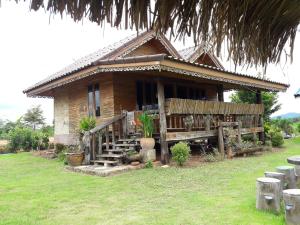 a small house with a porch and stairs in front of it at Phu Aram Khao Kho Resort in Khao Kho