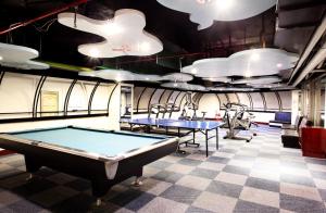 a pool table in a room with ping pong balls at Dongpo Ti Lun Hotel in Xinyi