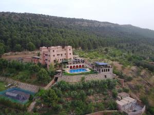 an aerial view of a large building on a hill at Kasbah Illy in Demnat