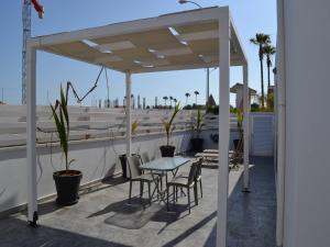 a patio with a table and chairs on a roof at Makronissos Beach Studio in Ayia Napa