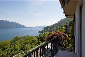 a balcony with a view of a body of water at Casa Balon in Oggebbio