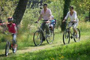 a group of people riding bikes in a field at La Gauviniere in Liez