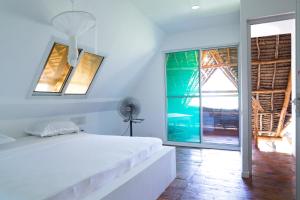 Voodi või voodid majutusasutuse Lazy Beach House toas