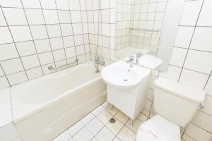 a bathroom with a sink and a tub and a toilet at Day Chen Hotel in Yilan City +26 photos