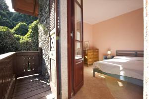 a bedroom with a bed and a door with a window at Villa Scagliola in Verbania