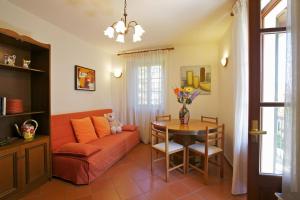 a living room with a couch and a table at Casa Bel Giardino in Cannobio