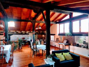 a living room with tables and chairs in a building at Agroturismo Ondarre in Segura