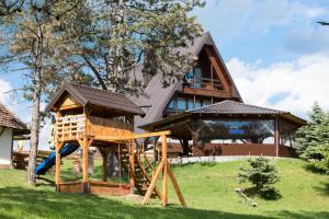 a house with a playground in front of it at Hotel Babino Brdo in Derventa