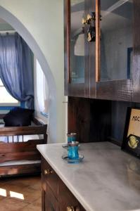 a kitchen counter with a blue candle on top of it at mikri vigla eksohiki katoikia in Mikri Vigla