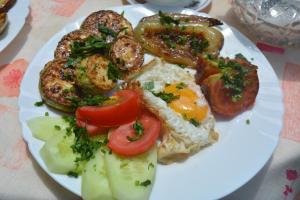 een bord ontbijtproducten met eieren en tomaten bij SUNNY SWEET HOME in Dilidzjan