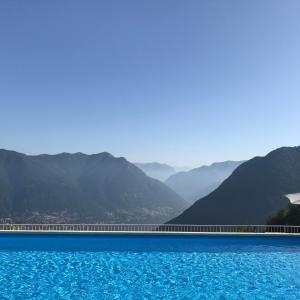 a large body of water with mountains in the background at Hotel Paradiso Como in Brunate