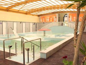 a large swimming pool in a building at Avra Spa Hotel in Loutra Edipsou