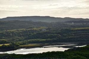 a view of a valley with a river and mountains at Killoran House in Dervaig