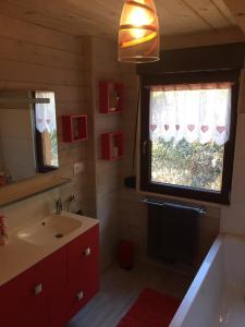 a bathroom with a sink and a window at Chalet du champs des semeaux in Wisches +146 photos