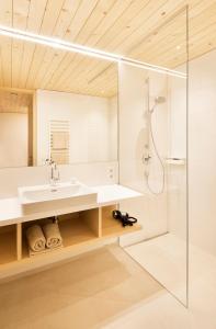 a bathroom with a sink and a shower at Hotel Tannahof in Au im Bregenzerwald