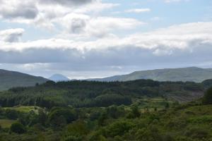 a view of a valley with mountains and forests at Killoran House in Dervaig
