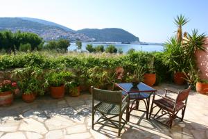 a patio with a table and chairs and plants at Spitalia Studios in Skopelos Town