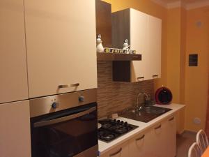 a small kitchen with a stove and a sink at Berenice in Taranto